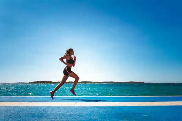 Woman running showing strong leg muscle Havering